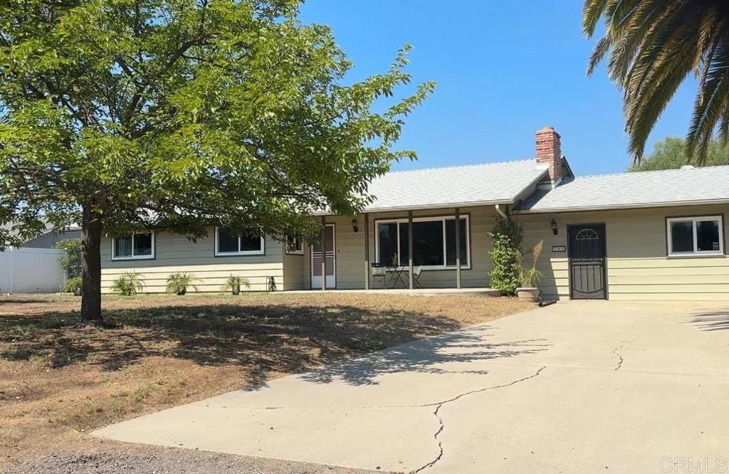 Welcome to 296 Durgin Street, a well-maintained single-story home offering space, flexibility, and horse-friendly living, minutes from the heart of Ramona. With over 2,500 square feet of living space on a flat, usable acre, this property offers exceptional value at a price below the typical price-per-square-foot for the area. Inside, this home has been thoughtfully updated with fresh interior paint, new fixtures, and door hardware. The kitchen features granite counters, plenty of cabinet space, and views of the backyard. The spacious living room offers a cozy brick fireplace, and the separate family room includes a wood-burning stove and bar area—ideal for entertaining or creating a game room. Other highlights include dual pane windows throughout, ceiling fans in all bedrooms, a secondary bathroom with dual sinks, and central AC for added functionality. Outdoors, you'll find covered patios in both the front and backyards, creating multiple spaces to relax and enjoy the peaceful setting. The backyard also includes two storage sheds, and the lot is fully usable with zoning for horses. With no HOA and ample space, there's room to park RVs or trailers, add a barn, paddock, workshop, or even a pool. The solar system is leased and will need to be assumed by the buyer.