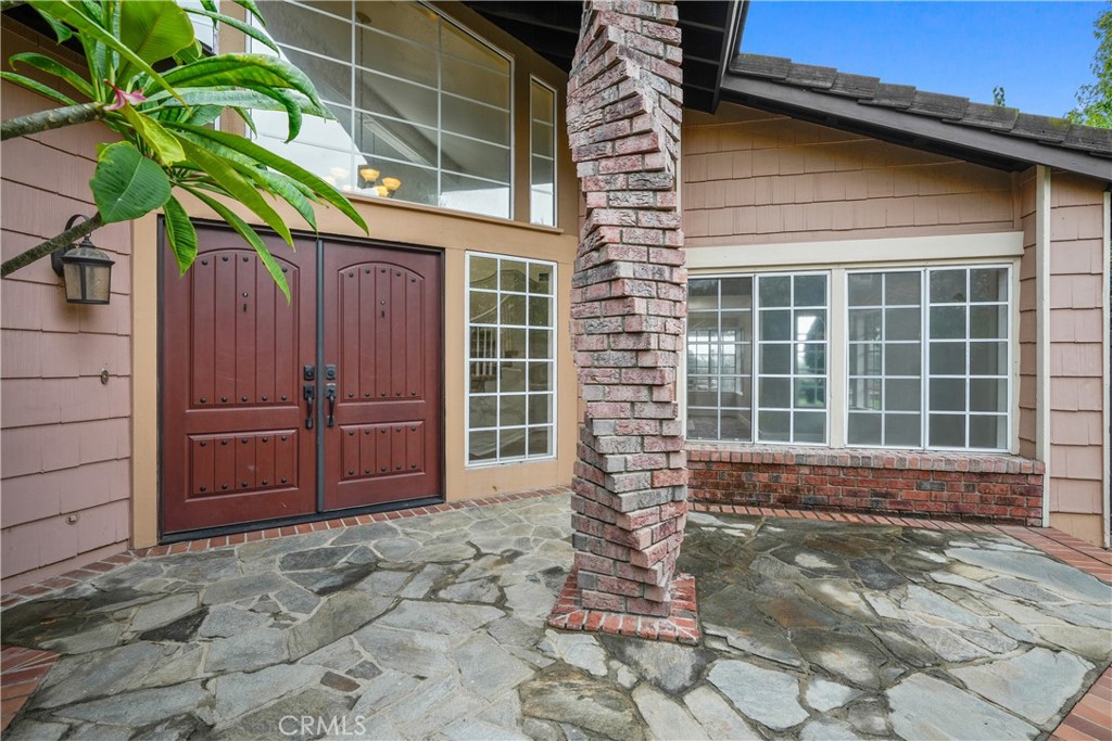 This home has it all, LOCATION, VIEW AND CUL-DE-SAC!! This Gorgeous 5 bedroom/3 bath home with views of the Saddleback Mountains. Located on a cul-de-sac in the highly sought-after neighborhood of Portola Hills. This sunshine filled home has an open concept floor plan with a gourmet remodeled kitchen (Quartz counters, GE stainless steel refrigerator, dishwasher, burner, double oven) open to the large family room. The formal living and dining rooms welcome you, with a curved staircase and views to the backyard. 5 bedrooms and 3 baths for your family to enjoy. Downstairs, there is a large bedroom and full bath with shower, indoor laundry, and access to a 3-car garage. Upstairs, the spacious master suite allows for great views off the oversized balcony and master bathroom has a custom tiled walk-in shower, double vanity and walk in closet. Three additional bedrooms and a full bath with double vanity and shower/tub combo. The spacious lot has a large entertaining bar with built-in barbecue, patio cover and lots of grassy area. There is a custom children's playhouse in the corner of the backyard. Beautiful double-door entry. 3rd garage converted for gym/office/storage. Walking distance to award-winning Portola Hills elementary school. HOA amenities include Olympic-sized swimming pool (salt water and heated), Spa, Pickle ball, basketball and lighted tennis courts. Community club house rental for parties and Sauna and Gym. Close to shopping, dining, & parks, Whiting Ranch & Aliso Creek trail.