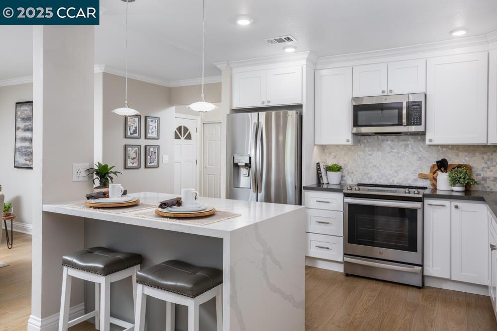 Beautiful remodeled Sonoma Wrap with additional full bath added in 2020 by Precision Building and Design. Walk in Ello and Allo custom shower with 7 water streams. Complete kitchen remodel from top to bottom with custom everything! Custom back splash compliments the quartz countertops; Kitchen drawers for easy access; pantry; extra cabinets in dining room, kitchen window looking out onto a beautiful oak tree; Fisher & Paykel two drawer dishwasher; counter depth refrigerator. Living and Dining room have custom HunterDouglas Roller and Designer Screen Shades with remote control. Laminate flooring throughout. Dual pane windows and slider. Wrap is enclosed with both heat and cool appliances. Wrap adds addiitional space for your hobbies, office, extra bedroom or whater your wish is.