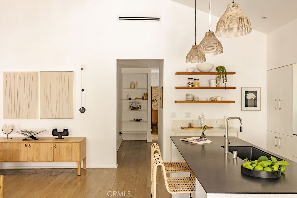 Stunning Modern Farmhouse in Atwater Village – 4BR, 3BA + Detached Studio
Discover a masterpiece by Allprace, nestled on an oversized lot in one of Atwater Village’s most sought-after enclaves. This 4-bedroom, 3-bathroom modern farmhouse, with a 360-sq-ft detached studio, offers 2,567sq ft of bold yet inviting living space, blending dramatic architecture with everyday comfort.
Step through custom Dutch doors into a breathtaking open-concept living, kitchen, and dining area, where soaring ceilings and a board-formed concrete fireplace create a striking first impression. Built-in shelving and cozy window seats add charm, while French doors in the living room seamlessly connect to the front yard. The chef’s kitchen is a dream, boasting a Gaggenau refrigerator, Bertazzoni range, sleek custom cabinetry, and leathered stone countertops. A spacious family room with French doors opens to the outdoors, perfect for entertaining.
The primary suite is a serene retreat with vaulted ceilings, a large walk-in closet, and a spa-like ensuite bath featuring a freestanding stone resin tub. A second master suite, ideal for guests, offers a walk-in closet, private backyard access, dual marble vanities, and a skylit bath. Two additional bedrooms share a stylish hallway bath with dual vanities, contemporary tilework, and a skylight.
Just steps from the North Atwater Bridge with direct Griffith Park access and a short stroll to Proof Bakery, Dune, and McCall’s Meat & Fish Co., this home blends luxury, lifestyle, and prime location. Don’t miss this Atwater Village gem!