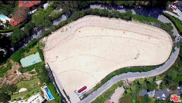 Located within the ultra prestigious East Gate of lower Bel-Air, 800 Stradella Rd. is a breathtaking approx. 2 acre promontory site, overlooking awe-inspiring jetliner views from downtown to the Pacific Ocean. This one of a kind development opportunity offers plans and ready to issue permits for a world class 30,000 Sq.Ft. architectural marvel designed by internationally renowned São Paulo, Brazil based Studio MK 27.