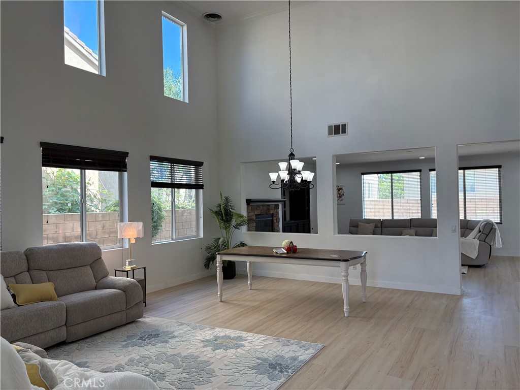Welcome to this beautifully upgraded 6-bedroom, 5-bath home located at the end of a quiet cul-de-sac in Eastvale’s Citrus Ranch community! Ideal for multi-generational living, this spacious layout offers 2 downstairs bedrooms with full baths, including a junior suite option. The chef’s kitchen features granite counters, large island, double ovens, and designer backsplash, flowing into a bright family room with fireplace. Soaring ceilings, wrought iron staircase, crown molding, and recessed lighting throughout. Recently upgraded with brand new interior and exterior paint and new laminate wood flooring. Upstairs boasts a large loft wired for home theater and access to a balcony with foothill views. Luxurious primary suite includes fireplace, dual walk-in closets, and spa-like bath. Over $80K in improvements, plus Tesla solar lease (~$254/mo), dual tankless water heaters, Halo water system, whole-house fan, Nest thermostats, and above-ground spa in the landscaped backyard. 3-car garage, butler’s pantry, and interior laundry room. Minutes to Riverwalk Park and award-winning schools including Roosevelt High & Rosa Parks Elementary (Corona-Norco USD).**