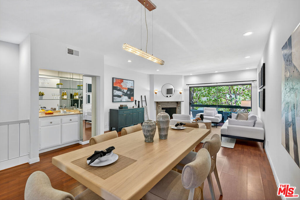 Welcome to this beautifully 2-bedroom, 2.5-bath reverse-floorplan townhome, tucked away on a peaceful, tree-lined street in the heart of Westwood.The upper level features a sun-drenched, expansive living room with soaring ceilings and a classic marble fireplaceperfect for cozy evenings. Adjacent to the formal dining area is a built-in wet bar, and sliding glass doors open to a generous balcony, ideal for outdoor dining or simply relaxing in the quiet surroundings.The chef's kitchen is a standout with custom tilework, stainless steel appliances, ample cabinetry, and a built-in desk alongside a convenient in-unit laundry area.Downstairs, the spacious primary suite offers two walk-in closets, a charming window seat, and a luxurious en-suite bath with granite countertops and travertine flooring. The second bedroom enjoys direct access to a large private patioperfect for morning coffee or evening relaxation.Additional highlights include two side-by-side parking spaces, plenty of guest parking, and access to a well-maintained community spa.Located just minutes from Century City, Beverly Hills, Westfield Mall, and UCLA, and within walking distance to top-rated Westwood Charter Elementary and local restaurants. Don't miss this rare opportunity to own in one of West LA's most sought-after neighborhoods!