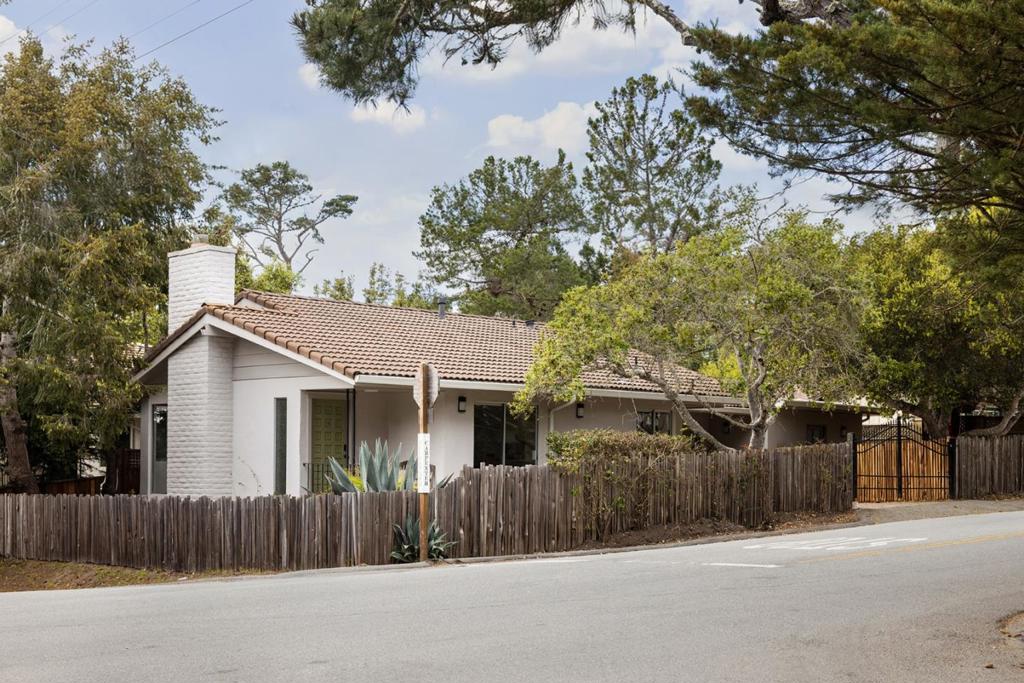 Located in the enchanting village of Carmel-by-the-Sea, this lovely 3-bedroom, 2.5-bathroom property includes a main residence and a recently built guest unit, offering coastal charm just a short stroll from downtown. The 1136sf main house is thoughtfully designed to maximize comfort and style. The spacious living area, adorned with beautiful hardwood floors and a cozy fireplace, provides a warm and inviting ambiance. Other highlights include a meticulously landscaped, private grape stake fence/gated yard, a charming patio with bar seating by the kitchen window perfect for alfresco dining, an attached spacious one-car garage, and off street driveway parking. The 408sf guest unit with private gated entrance offers a rental opportunity, or extra room for guests. Just minutes from Carmel's renowned shops, restaurants, art galleries, and pristine beaches, this property offers its lucky new owners the quintessential coastal lifestyle.