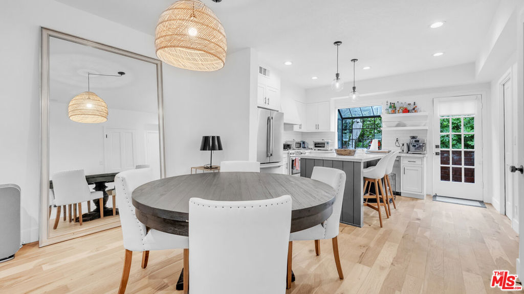 Just off Ocean Avenue, this Santa Monica townhome puts you a half block from Palisades Park and the bluffs. Spanning three levels with its own interior elevator and roughly 1,577 square feet, the layout is both functional and inviting. The remodeled kitchen opens to a private patio ideal for coffee in the morning or dinner outdoors. The living room gets great natural light and centers on a wood burning fireplace. Upstairs you'll find a bright guest bedroom with full bath, laundry, and a den or office. The top floor is dedicated to the primary suite with vaulted ceilings, a walk in closet, private terrace, and a bath with double vanity, soaking tub, and glass shower. Oak floors, central air, and two side by side parking spaces with storage add to the comfort. San Vicente Ocean Townhomes is a small gated community built in 1982, tucked into a quiet setting with open space to the east, yet steps to Montana and the beach. Clean, easy, and ready.