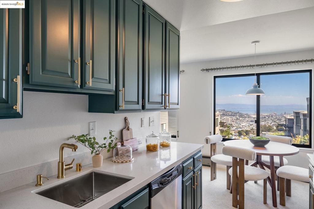 City & Bay views from every room in this stylishly updated 2-bedroom 2-bath condo! Be greeted by an on-trend kitchen featuring moody cabinets, whimsical flooring, brand-new quartz counters, and newer stainless steel appliances. Kitchen flows to the dining area with incredible Bay views. Cozy up to the gas fireplace in the spacious living room. Newly updated generous hall bath is across from the guest bedroom, where you'll find a chic vanity, new medicine cabinet/ mirror, new shower panels, bathtub and new bath fixtures. Ample primary bedroom is further down with a private balcony and a recently updated ensuite bathroom that has a new vanity, lighting, frameless shower doors, bath fixtures and flooring. Enjoy your morning coffee on your balcony. Freshly painted interior with new carpeting and well-appointed light fixtures throughout. One-car deeded parking space in the street-level garage. The exterior of the building was just painted. Well-run and responsive HOA. Diamond Heights Shopping Center and Upper Douglass Dog Park are a block away. Easy access to fwy 280.
