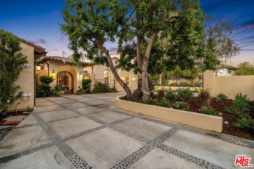 SINGLE STORY-NO STEPS. Gated oasis built as new in 2010. Set back off the street with a circular driveway. The dramatic courtyard entry is showcased by a fireplace and fountain welcoming you to a custom-built home designed by a leading architect for his family. Wonderful spacious floor plan, with high beamed and coffered ceilings with many skylights. The kitchen is open to the family room fit for Prime Time TV includes: massive center island, 48 refrigerator/freezer, 48" oven/range with pot filler, 2 sinks, 2 dishwashers, warming drawer, wine frig, Bosch coffee maker, microwave, fireplace. Enjoy the formal living room with high beamed ceilings, stone fireplace open formal dining area and walk-in wine room overlooking the beautifully landscaped yard. Warm inviting study open to courtyard, could be 6th bedroom. Retreat to your romantic master suite featuring sitting area, fireplace, tv. 2 walk-in closets and private patio, bath with sauna plus spa tub and private water closet. Relax in the beautifully landscaped yard with huge pool, spa, arbor, lots of green grass, room for ADU or sports court or both. Noteworthy: 8 Ft Doors, wood and stone floors, alarm system, French doors, over 18,000 sf of flat land. Located in the estate area of Tarzana. Ez Westside, Beach and Freeway access. Possible disability access and room for RV. Tarzana offers great walking and hiking trails, country clubs, golf and tennis courses , restaurants and entertainment.