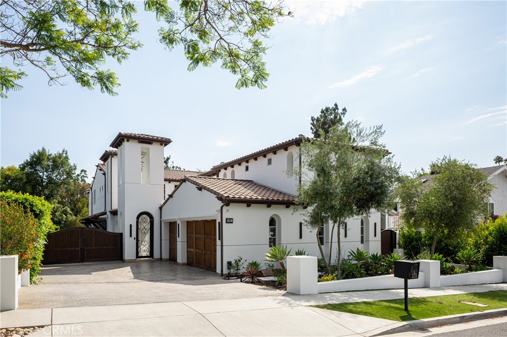 375 Santa Isabel Avenue offers a blend of modern luxury and coastal ease in the heart of Newport Beach’s scenic Back Bay. This 5-bedroom, 5.5-bath estate spans approx. 5,200 sq ft on a 9,816 sq ft lot, just minutes from Balboa Island, Fashion Island, and world-class beaches. A cobblestone drive provides access to an oversized, finished three car garage. Through an iron gate, a covered walkway past a large central atrium leads to the front door where light and volume are the main attraction. With soaring two story ceilings, multiple fire features and stackable walls of sliding glass which let the outside in. The chef’s kitchen and adjoining scullery equipped with an additional cooking space are ideal for entertaining, while the indoor-outdoor dining area, and multiple outdoor patios invites year-round gatherings around the outdoor fireplace. The main-level primary suite is a true retreat with a spa-inspired bath and large, custom walk-in closet. Upstairs, a spacious loft and three additional ensuite bedrooms accompany a detached guest suite with a separate entrance and a balcony. Lush landscaping and mature hedges surround outside spaces designed for celebrations or relaxed evenings under the stars. A sanctuary of style, space, and coastal living—375 Santa Isabel is Newport Beach at its finest.