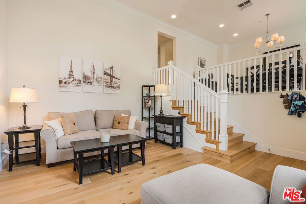 Welcome to this stunning townhome with direct access and private garage in the sought-after Tapestry community of Playa Vista. This ideal floor plan offers three true bedrooms all on one floor. Available furnished or unfurnished, this home showcases thoughtful upgrades throughout and a layout designed for both comfort and style. The entryway sets the tone with soaring ceilings and expansive windows that flood the space with natural light. The beautifully updated kitchen features stainless steel appliances, bright white cabinets and seamlessly connects to the living room, where a cozy fireplace and balcony create the perfect setting for relaxation or entertaining. Upstairs, you'll find the beautiful primary suite as well as two bedrooms separated by a full bathroom. One of the bedrooms includes custom built-ins, making it an ideal home office or creative workspace. The spacious primary suite offers high ceilings, a walk-in closet, and a luxurious en-suite bathroom with dual vanities, a soaking tub, and a separate shower. Just downstairs, you'll find the laundry room, equipped with washer and dryer, a versatile bonus room, and a private 2-car garage with direct access to the home. Located just moments from CenterPointe Club and The Resort - with premier gym and pool facilities - this home also offers easy access to Concert Park, Runway, Whole Foods, Cinemark, and an array of dining, shopping, and so much more!
