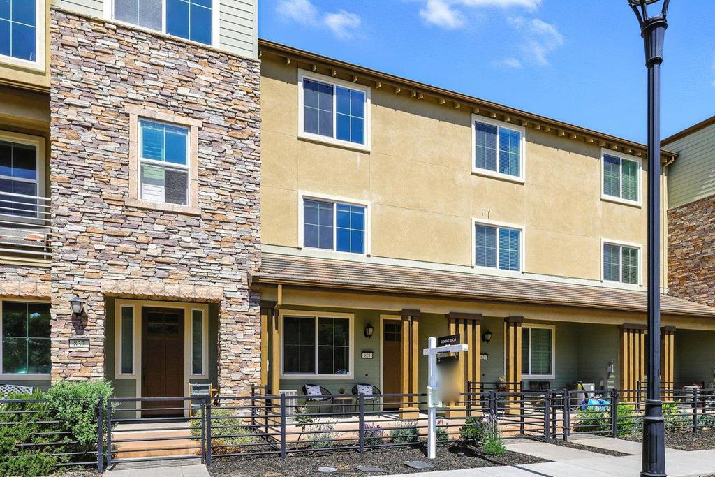 Welcome to this beautifully upgraded townhome featuring a bright and open floor plan. The ground-level bedroom comes with a full bathroom and direct access to the finished two-car attached garage plus a private driveway for two additional parking spaces. The front yard is landscaped with beautiful lavenders, adding charm and fragrance to your entry. The chefs kitchen is equipped with stainless steel appliances, a large central island, cherry cabinetry, and elegant stone countertops. Adjacent dining and living areas flow seamlessly onto an expansive balcony, perfect for enjoying your morning coffee. New carpet has been installed throughout the bedrooms, with wood floors in the main living areas. All rooms are fitted with window treatments for privacy and comfort. Upstairs, a luxurious master suite with a walk-in closet, oversized shower, and dual sink vanity. Two additional bedrooms have their own bathrooms, providing both comfort and privacy. Plenty of storage space is available throughout. Residents enjoy access to the exclusive 12,000 SqFt Avenue One clubhouse, featuring a pool, gym, yoga room, spa, and a spacious event room with gourmet kitchen. Prime location-walking distance to Costco, restaurants, library, schools, community garden, and minutes to major freeways.