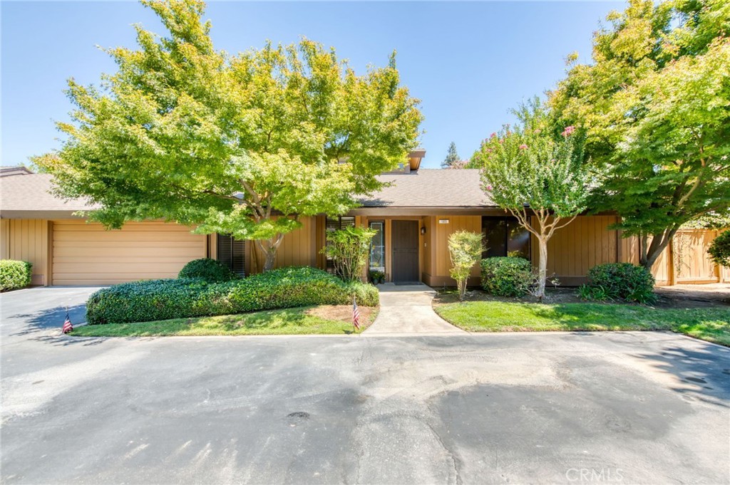 Welcome to The Fig Gardens gated community. This handsome single level condo is ready for immediate move in with an updated kitchen and fresh paint throughout. You will love the layout with 3 large bedrooms and the vaulted ceiling in the great room complete with a fireplace. The kitchen was completely remodeled and features beautiful cabinets with custom tile work and granite counters with stainless appliances, a professional gas cooktop. and a charming garden window. There are wood floors throughout and all rooms are painted in a creamy ivory. The backyard is private and features a small pergola and concrete area with a large side yard area as well. There is a two-car garage with built-in storage and also plenty of guest parking. This is a lovely and quiet community with mature trees, grassy areas and a pool/spa for your enjoyment. Go see it today!