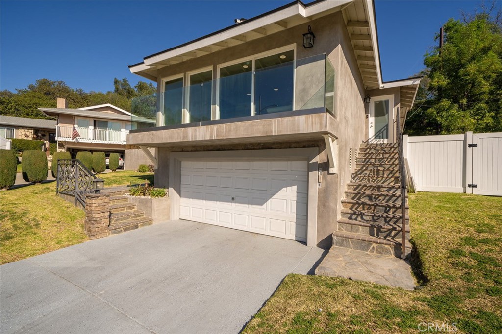 Beautifully updated three bedroom Glendora pool home! Located at the end of a cul-de-sac street with amazing views, this gorgeous home features formal entry, formal living room with fireplace with multiple slider doors leading to view balcony, open kitchen with newer cabinets, quartz counters, stainless appliances, and kitchen eating area. Spacious primary suite with oversized shower, two additional bedrooms, and hallway bathroom with large shower. Gated pool and spa, covered patio, and separate yard for children's play. Two car attached garage with electric car charger inside. Located in the Charter Oak School District.