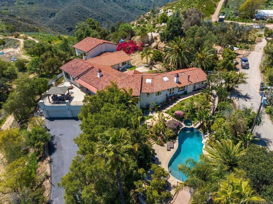 Owner Financing Considered.  Price Improvement - Private Luxury Estate on 10.72 Acres | Equestrian • Motocross • Vineyard • Dog Breeding potential.  Experience the best of luxury rural living at 10845 Mystery Mountain Rd — a secluded, single-story estate at the end of a quiet road with unmatched privacy, sweeping mountain views, and boundless potential. This 4BR, 3.5BA home offers over 5,000 sq ft of sun-drenched space, a gourmet kitchen, indoor sports court, view decks, and a resort-style pool with a 50-ft water slide — your own tropical paradise.  Zoned A70 with potential ag water rates, this property is ideal for equestrian use, a boutique vineyard, hobby farm, or sustainable off-grid retreat. Adventure awaits with your own motocross/ATV track, while the detached garage/workshop offers room for toys, tools, or expansion. All this just 10 mins to I-15 and 30 mins to Temecula or the coast. Seller operates a dog breeding business out of the property with significant upgrades to accommodate numerous dogs.  A rare blend of luxury, lifestyle, and land — this is more than a home; it’s your dream property.