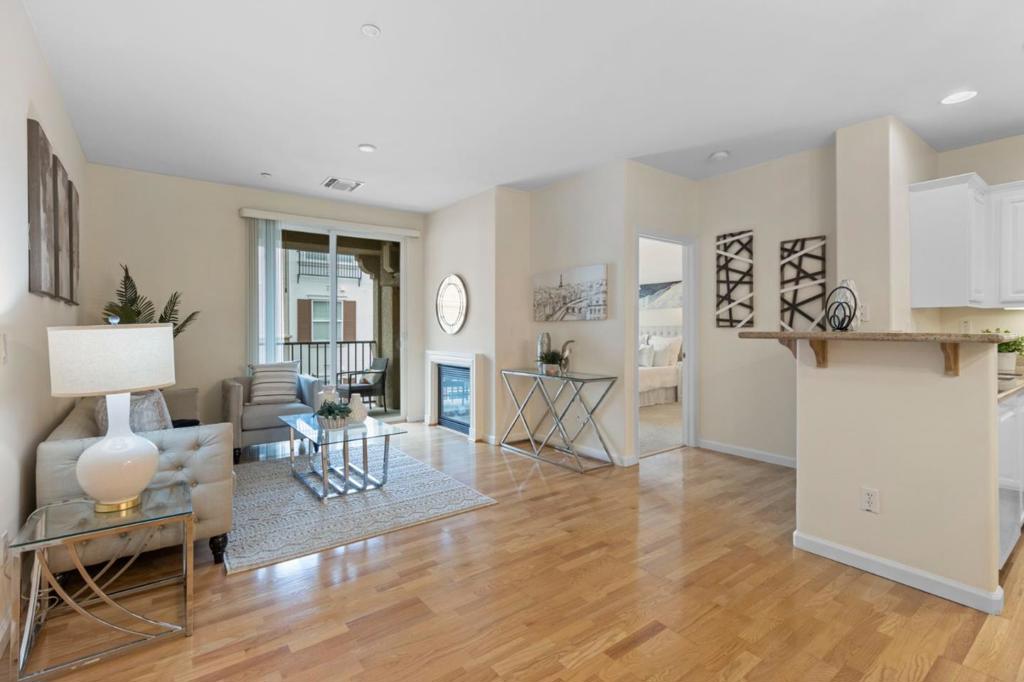 Welcome to 3275 Dublin Blvd #306 a beautifully updated 2-bed, 2-bath condo in the prestigious gated community of The Terraces at Dublin Ranch Villages. This unit offers 1,066 sq. ft. of well-designed living space with an open layout that seamlessly connects the living, dining, and kitchen areas. Enjoy a cozy fireplace and direct access to your private balcony, ideal for relaxing or entertaining. The updated kitchen features granite countertops, white cabinetry, and a functional flow into the main living space. The primary suite includes a spacious walk-in closet and an en-suite bath with dual sinks and a walk-in shower. The second bedroom is perfect for guests or a home office, with a full bath featuring a shower-over-tub just across the hall. Additional features include in-unit laundry, central A/C, and two assigned parking spaces in a secure underground garage. Residents enjoy resort-style amenities such as a pool, spa, fitness center, clubhouse. Located near top-rated schools, BART, shopping, dining, and easy access to 580/680, this move-in-ready condo offers the best of comfort, convenience, and East Dublin living.