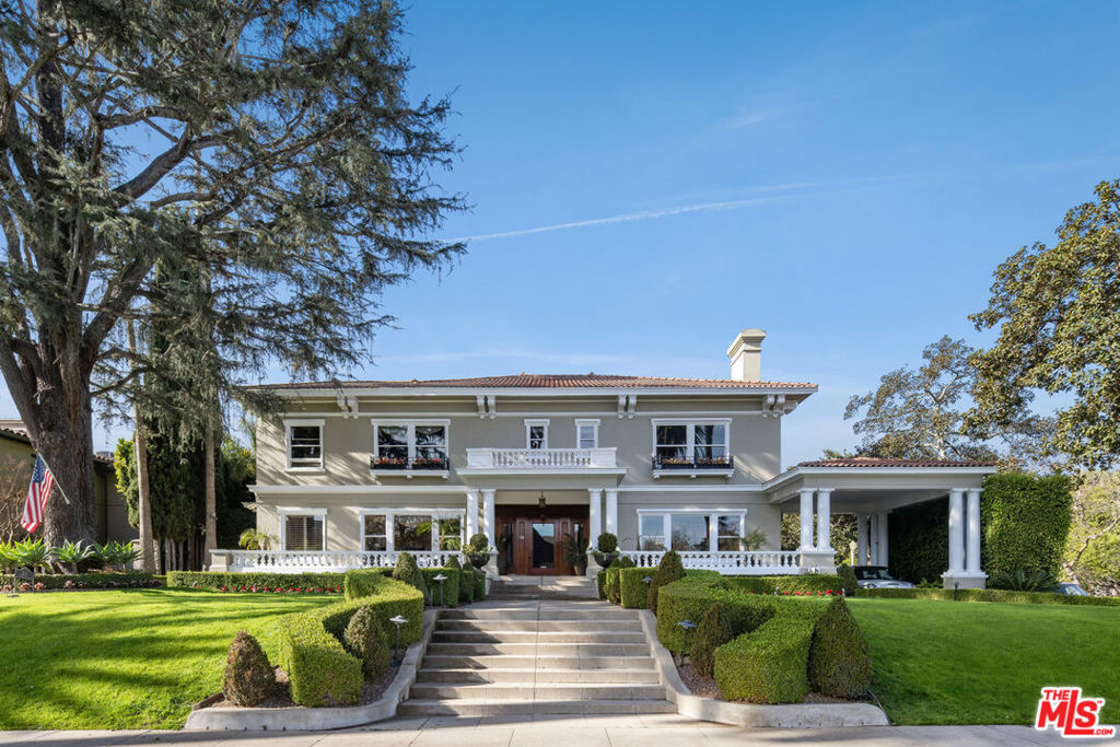Welcome to this exquisite Windsor Square estate, a stunning blend of historic charm and modern luxury. This home boasts timeless craftsmanship, elegant architectural details, and luxurious finishes throughout. The grand living and family rooms feature large windows, intricate woodwork, and beautiful fireplaces, creating spaces that are both inviting and refined. A formal dining room sets the stage for unforgettable gatherings, while the chef's kitchen combines classic design with modern convenience, offering top-of-the-line appliances and ample space. The property is steeped in history and charm, offering a glimpse into Old Hollywood. Imagine driving by during daylight hours and witnessing people from around the world stopping to capture the iconic view unique to this block, the historic and magical Hollywood Sign in all its glory, flanked by a palm tree-lined street. It's a breathtaking sight that never gets old. Over the years, this home has served as the backdrop for countless movies, television shows, music videos, and even high-end brand runway fashion shows, with hundreds of people paying to photograph this historic property. The primary suite serves as a serene retreat with a spacious dressing area and a spa-like marble bathroom, while additional bedrooms are generously sized, each with its own unique charm. A private guesthouse adds to the home's appeal, complete with a kitchen and bathroom, offering an ideal space for visitors or additional flexibility. One of the standout features of the property is its history as an entertainment haven. Originally built as a game room for entertaining rather than a basement, the space once featured one of the only private bowling lanes in Hancock Park. Though the lane was removed a few years ago in preparation for a screening room (a project that was sidelined for other pursuits), the original ball return still remains. Picture the fireplace lit, friends and family bowling, poker being played in the adjacent side room, an Old Hollywood "man cave" designed for vibrant gatherings and lively fun. Outside, the lushly landscaped backyard serves as a secluded oasis with a sparkling pool, spa, and spacious patio perfect for entertaining or relaxing. Stained-glass windows, balconies, and period-inspired tilework enhance the home's timeless allure, while modern updates ensure comfort and convenience. This Windsor Square masterpiece is more than just a home, it's a lifestyle and a rare opportunity to own an elegant estate that perfectly balances history, modern living, and the magic of Hollywood.