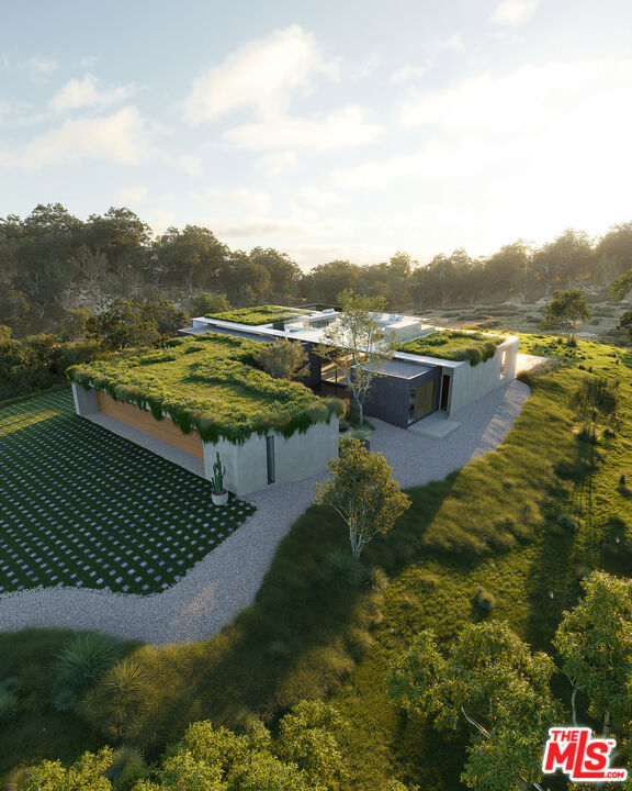 A rare fusion of architectural brilliance, elemental beauty, and masterful craftsmanship, this extraordinary Point Dume estate is a sanctuary of elegance and innovation. Designed by world-renowned Minarc and MYMM Interior Design Studio, this 6-bedroom, 6.5-bathroom masterpiece spans 6,375 square feet of single-level sophistication. Constructed with structural and light-gauge steel, it features rooftop sprinklers and a top-tier fire rating, blending strength with refined luxury. European oak floors and Neolith slab finishes create an atmosphere of understated elegance, enhanced by smart home automation, ambient lighting, and an immersive sound system. A private executive office with a discreet entrance offers a secluded workspace.Expansive living and family rooms flow seamlessly to an outdoor oasis, featuring a sprawling deck, gourmet kitchen, and a stunning 75-foot infinity pool with breathtaking canyon views. A 2,000-square-foot green rooftop garden provides an unparalleled retreat with panoramic vistas of Malibu's canyons and mountains. The 1,075-square-foot lower level is dedicated to indulgence, boasting a state-of-the-art gym, steam shower, sauna, and a private home theater with a 160-inch screen. The primary suite exudes serenity with a spa-inspired ensuite and private balcony. Nestled on a quiet cul-de-sac on 1.6 acres of pristine land, framed by towering sycamores, a seasonal stream, and sweeping canyon views, this estate offers rare seclusion just moments from Malibu's finest beaches and boutiques. New construction in Point Dume, this home is designed to inspire, blending modern sophistication with Malibu's effortless beauty. Schedule a private tour to experience the pinnacle of coastal luxury.