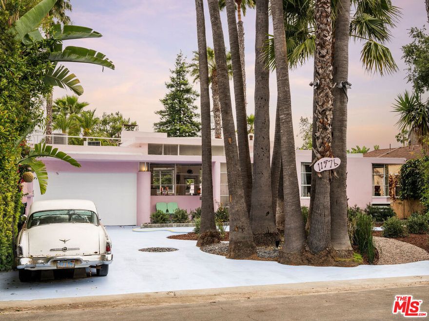 Presenting an excellent opportunity for the modern collector, Hollywood history buff, or developer/builder/end-user: An original portfolio piece by American architect William Kesling, known for designing a historic collection of homes in the Streamline Moderne style (a subtype of Art Deco aptly dubbed "ocean liner" style by the French) throughout Los Angeles. Given its close proximity to studios, there's no surprise that it was originally used as a party haven for Hollywood's tastemakers, but that was just the beginning. In 1980, this iconic residence was purchased by two-time Grammy-winning, Emmy- and Tony-nominated songwriter and art director Allee Willis, and the rest is nothing short of music history. Willis gave the architectural diamond its baby pink hue, but otherwise preserved its original identity while performing a complete restoration. Here, the former Motown Records dreamer would host lavish gatherings and themed jamborees which quickly became notorious throughout Hollywood's social circles, her exclusive guest list including the likes of Cher and Joni Mitchell. The home would also serve as the birthplace of her vast body of work, resulting in a long list of smash-hit songs such as "September" and "Boogie Wonderland" by Earth, Wind & Fire, "Neutron Dance" by The Pointer Sisters, and "I'll Be There for You," the indelible theme song of NBC's hit television show Friends. Over the years, she welcomed legendary recording artists and collaborators to the on-site state-of-the-art music studio (James Brown, Bob Dylan, and Cyndi Lauper are just a few). With an insatiable desire to create, she also sculpted and painted numerous art pieces. Willis was also an avid collector, adorning her home with countless pop culture treasures from the 1950s, '60s, '70s, and '80s. Of her penchant for throwing parties, Willis notably once said in an interview, "I always had a music career, an art career, set designer, film and video, technology. The parties really became the only place I could combine everything." Her storied festivities have been covered in publications as diverse as People, Life, The New York Times, The Wall Street Journal, and Rolling Stone. Beneath towering palms, the '50s-inspired grounds feature a bowling-ball garden, private sand beach, and newly built poolside shower for the modern reveler.