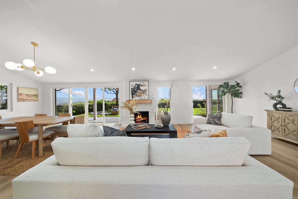 Experience Coastal Sophistication in Monarch Summit I Set high on a hill in the sought-after Monarch Summit I community, this fully remodeled, single-level 2-bedroom, 2-bathroom gem captures views of mountains, city lights, and the coastline. Enter through the private courtyard and step into an open, airy living space where large sliding doors flank a sleek, cozy fireplace with a wood mantel, filling the home with natural light. Oak-toned flooring enhances the warmth and sophistication throughout, while the living and dining areas seamlessly connect to the back courtyard—an inviting space to relax and enjoy the refreshing coastal breeze. The brand-new kitchen is both stylish and functional, featuring white shaker cabinets for ample storage, stunning countertops, and sleek floating shelves for convenience and display. State-of-the-art appliances make cooking a pleasure, while the open layout encourages social interaction—perfect for everyday meals and entertaining guests. The primary bedroom is a serene retreat, offering picturesque greenbelt and mountain views, abundant natural light, and sliding doors that open to the courtyard. The en-suite bath exudes luxury with a spacious walk-in shower with a bench, designer tiles, and a large oak vanity with dual sinks and ample storage. The second bedroom is equally inviting, with abundant light and sliding doors, while the fully renovated second bathroom maintains the home’s calming, neutral tone and thoughtful design touches. A brand-new HVAC system ensures year-round comfort, enhancing this home’s modern upgrades. Ideally located in a cul-de-sac, this home sits across the street from some of Monarch Summit I’s top amenities, including a pool, spa, and clubhouse. The peaceful community is surrounded by gorgeous ocean and mountain views, offering a tranquil yet convenient lifestyle. Enjoy close proximity to Dana Point Harbor, world-class resorts and golf courses, shopping centers, dining, parks, and scenic walkways. Move-in ready and designed for luxurious coastal living—don’t miss this rare opportunity to call Monarch Summit I home!