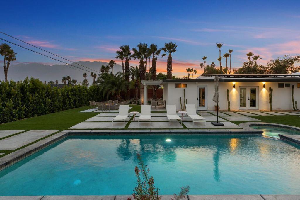 Palm Springs is a long-time favorite desert destination, and this remodeled & fully furnished mid-century modern home is ready to help you experience it all at your fingertips. Located in Desert Park Estates and situated on an expansive lot with gorgeous mountain views! Fully owned solar includes sun power panels w/25-year transferable warranty. Inside features light & bright decor, with a moody and elegant second living area (or bonus rm) at the back of the house. Kitchen, bedrooms & baths w/modern touches throughout. With a luxurious backyard featuring numerous patio areas, a pool, hot tub and massive firepit, you will have plenty of space to lounge and relax under the California sun. Large 2 car detached garage w/ample workspace & laundry hook ups. Airport & downtown Palm Springs is an approximately ten-minute drive away. Convenient location with shopping, entertainment and dining nearby. Enjoy easy & fun adventure day trips to Coachella Valley or Joshua National Park!