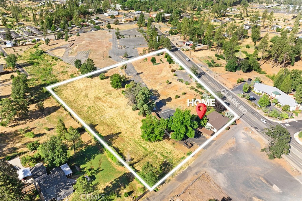 Incredible potential for a large Multi Unit complex in the heart of Paradise. Property consists of two parcels, with total of 5.09 acres MF zoning. Prior to Camp Fire was Shelter Cover Apartments, 32 units with carports and 8 total buildings, 4 units per. Currently is a 1- 4 unit building onsite, which was completely renovated after fire, and all new, 4-1bedroom units. Located in center of proposed sewer system area, which would allow for up to 30 units per acre if and when sewer connection becomes available. Currently approved for 32 units, If the buyer is interested in increasing the total unit count to 75, that could potentially be supported by the zoning which allows up to 15 units/ac with the use a clustered wastewater system (common area engineered system). That process starts with the buyer connecting with a wastewater engineer to do wastewater calculations, and soils testing, to submit to the Onsite Wastewater Division for review and approval through a “Land Use Review. If and when sewer take place, the unit count could be increased to 150 units making this an outstanding long term income stream or potentially massive re sale value. Several points for ingress/egress in place, with all the older septic tanks removed, making it easier for developing, and laying out the site for flow with unit placement, with the current 4 unit building tucked to North West corner at Lovely Lane. The potential here is incredible, investment groups welcome, or the savoy individual investor!!