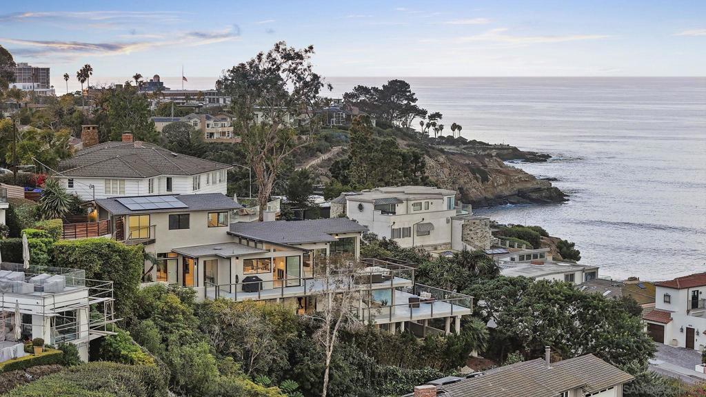 Tucked away at the end of Ludington Lane, this recently remodeled hillside home blends privacy, comfort, and sweeping ocean views. Nearly every room showcases the coastline, with expansive windows and terraces that connect indoor and outdoor living. The four bedrooms each feature en-suite baths and access to view decks, while the primary suite offers a spa-like bath, walk-in closet, and a spacious terrace overlooking the horizon. Just minutes from The Village of La Jolla, enjoy world-class dining, boutique shopping, and iconic beaches—while returning home to your own private sanctuary.