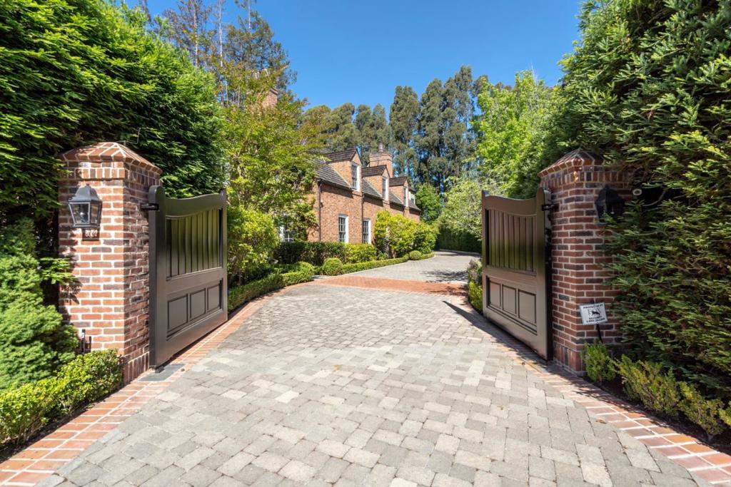 Timeless elegance abounds this classic residence in a hidden cul-de-sac that shares a story of Hillsborough's past. Built in 1931 as part of the compound for the Clark family while the "House-on-A-Hill" was being built, this carriage house of Cotswold design and influence has evolved into a mini estate on a level lot of approx. 39,000 square feet with complete privacy. The 5704 sq ft main house boasts grand-scale public rooms, high ceilings, beautiful windows and floors. All 5 bedrooms en-suites are on the upper level. The 707 sq ft ADU is a home away from home for extended family and guests. Take your entertainment and gatherings to the outdoors - game day at the pool terrace, practice at the basketball court, afternoon tea or book club at the front or inner courtyard, plant your seasonal veggies or simply take a cool shelter on the deck under the redwood tree. A separate pool house of 568 sq ft is NOT included in the living area. It is quality suburban living at its best!