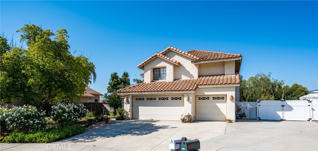 NO HOA! NO HOA! NO HOA! Welcome to this 4 bedroom 2.5 bath, 3-car garage home located at the end of a cul-de-sac in the Windsong community. This home welcomes you with cathedral ceilings, laminated wood and tile ceramic flooring throughout first floor. The kitchen features a window that overlooks a very cozy and spacious garden. Formal living room and cozy family room with fireplace to spend many hours of family fun. Separate formal dining area. Large laundry room conveniently located downstairs with access to back yard. Upstairs we have master bedroom with a walk in closet, cathedral ceilings and its private bathroom with a large tub. You will also find 3 more spacious bedrooms. Back yard features an amazing open concreted space to park your RV and/or boat, covered patio for family gatherings, and there’s still room to build your dream pool, the possibilities are endless. This home is conveniently located close to 15 fwy, schools, stores and restaurants. Don’t miss out on this opportunity to make this home yours!!