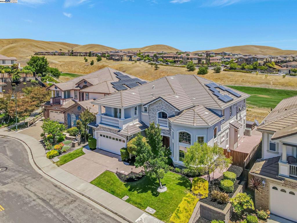 MODEL HOME! Stunning executive home with breathtaking valley and golf course views, best enjoyed from your private backyard oasis featuring a 16-person spa and 5-person above-ground spa—ideal for entertaining. Enter through a grand foyer with an elegant wrought iron staircase, setting the tone for timeless sophistication. A stately library with built-in bookshelves offers the perfect office or reading space. The gourmet kitchen opens to both the family and living rooms for seamless flow. Upstairs, the luxurious master suite features a fireplace, expansive windows with automatic shades, and scenic views, while a large open loft provides a versatile retreat. Includes a 14-camera security system, water softener, and built-in speakers throughout. Community amenities include an Olympic-size pool and tennis court within walking distance. One of only TWO original model homes in Dublin Ranch! Near top-rated schools, restaurants, shopping, BART, and more—this rare gem won’t last!