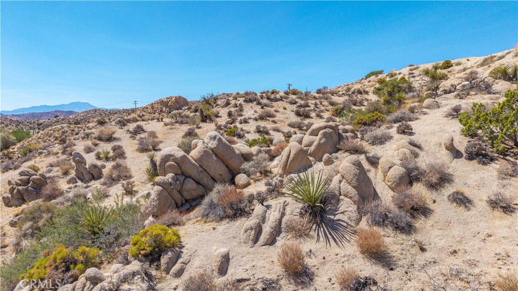This 2.31 acre parcel in Yucca Valley’s sought-after Pinion Ridge area offers the perfect opportunity to create a desert retreat. The lot is buildable and captures wide views of the surrounding landscape, making it a great spot for a primary residence, vacation home, or short-term rental. Pinion Ridge is known for its peaceful setting while still being close to town conveniences. Just a short drive brings you to Joshua Tree National Park, Pioneertown’s live music at Pappy & Harriet’s, and the many galleries, shops, and restaurants in Joshua Tree and Yucca Valley. Hiking, rock climbing, and stargazing are all part of the lifestyle here. This property provides a chance to bring your vision to life in one of the High Desert’s most desirable locations.