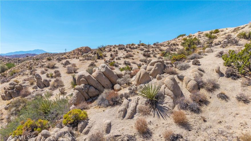 This 2.31 acre parcel in Yucca Valley’s sought-after Pinion Ridge area offers the perfect opportunity to create a desert retreat. The lot is buildable and captures wide views of the surrounding landscape, making it a great spot for a primary residence, vacation home, or short-term rental. Pinion Ridge is known for its peaceful setting while still being close to town conveniences. Just a short drive brings you to Joshua Tree National Park, Pioneertown’s live music at Pappy & Harriet’s, and the many galleries, shops, and restaurants in Joshua Tree and Yucca Valley. Hiking, rock climbing, and stargazing are all part of the lifestyle here. This property provides a chance to bring your vision to life in one of the High Desert’s most desirable locations.