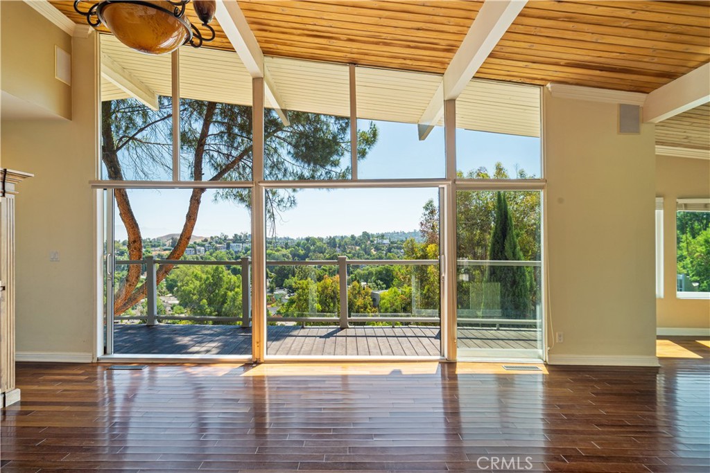 Mid-Century Modern Gem South of the Boulevard! Discover this amazing Woodland Hills pocket and this architecturally striking single-level mid-century retreat. Inside, the open-concept layout is flooded with natural light from expansive walls of glass providing peaceful treetop vistas and Valley views. The double paned, double sliding glass door provides indoor-outdoor flow. Thoughtfully designed living space creates an inviting atmosphere perfect for both everyday living and entertaining. Showcasing two bedrooms, two bathrooms, and a flexible bonus room offers endless possibilities - home office, creative studio, or guest space. Nestled in one of Woodland Hills’ most coveted SoBlvd neighborhoods, this home blends iconic design with a unique sense of privacy and sophistication. You’ll also enjoy close proximity to acclaimed dining, shopping, scenic hiking /biking trails, and convenient freeway access.