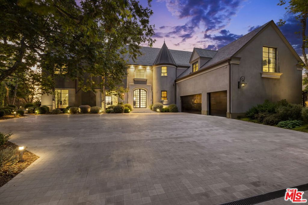 Experience ultimate exclusivity and unparalleled luxury in this French modern transitional. Located in Bel-Air's Stone Ridge Estates situated in a guard-gated community of only 11 homes, the residence is positioned at the back of the private cul de sac optimizing breathtaking city views and privacy. A very rare combination of privacy, 24 hour gated security, a modern home with 180 degree city and mountain views in an estate setting with large grounds. Step inside and discover expansive open living spaces, tasteful finishes and a seamless blend of classic and modern design with wide plank wood floors throughout There is a causal sophistication which gives you the optionality to live relaxed on a daily basis and entertain a large group in a magical setting. The heart of this home is its open-concept family room flowing into a gourmet kitchen equipped with a double island, 60 inch La Cornue dual oven range with 9 burners and top-tier appliances. There is a quaint breakfast area overlooking the garden and a formal dining and living room, where large windows fill the home with natural light. There is an elegant office overlooking the views, a top of the line fitness center, a poker-game room or optional maids room. Move upstairs to the private spaces which are tranquil and quiet and an inviting corridor takes you into the grand primary suite which has a luxurious bathroom, a generously sized walk-in closet and a terrace overlooking the skyline. There are four more well-proportioned bedrooms upstairs including a junior primary suite and a cozy den on the landing. There is a secondary back staircase for convenience and a basement level with polished concrete floors which holds multiple wine refrigerators and has wall to wall built-in cabinetry to maximize storage. The enchanting grounds has sprawling lawns, beautiful gardens and citrus, pomegranate, Jacarandas, Sycamores and Oak trees. The magnificent pool and jacuzzi anchors the yard and soaks up the sunshine throughout the afternoon. There is an outdoor barbecue-kitchen area as well as numerous moments to chill around three fire pits and take in the views. When you are in the mood for movement and fitness there is a sports court, outdoor wellness area with an infrared sauna and cold plunge. Available to Lease fully furnished.