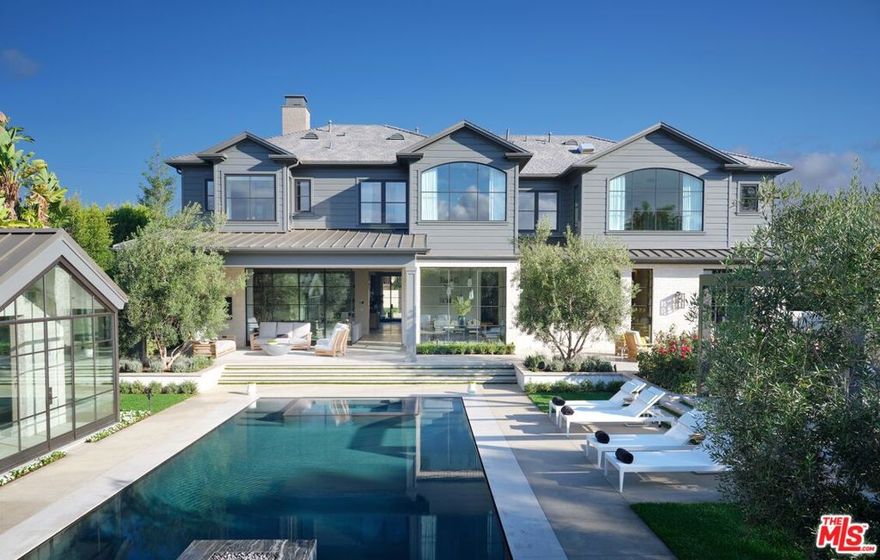 "A Winning Combination" New Masterpiece by Adam Hunter Design, 3.5 years in the making. By far the finest construction in Brentwood Park. Custom in every moment and detail, from inlaid marble slab floors to automated steel doors and floating Amuneal chrome cabinets. Over 11,280sqft of exquisite quality and impeccable style. Gracious and casual floor plan offers living room adjacent to lacquered dining room, fluted 3-story staircase, elegant office and the heart of the home an informal living room. Waterworks gourmet kitchen belongs in a showroom. Upstairs one finds a primary bedroom suite with sitting room, editorial primary bath in book matched Calacatta Cielo marble and double closets. Total of 6 bedroom and 9 baths. Entertainment floor offers elements one would find on the finest yacht, walls wrapped in custom grey leather panels and screening room with blush-colored mohair seating. Wellness center with plunge pool, massage room and gym. The grounds offer an epic zero-edge infinity pool with fire feature, pool house with bath and an alfresco dining pavilion. A rare offering. Brentwood Park's Finest Jewel.