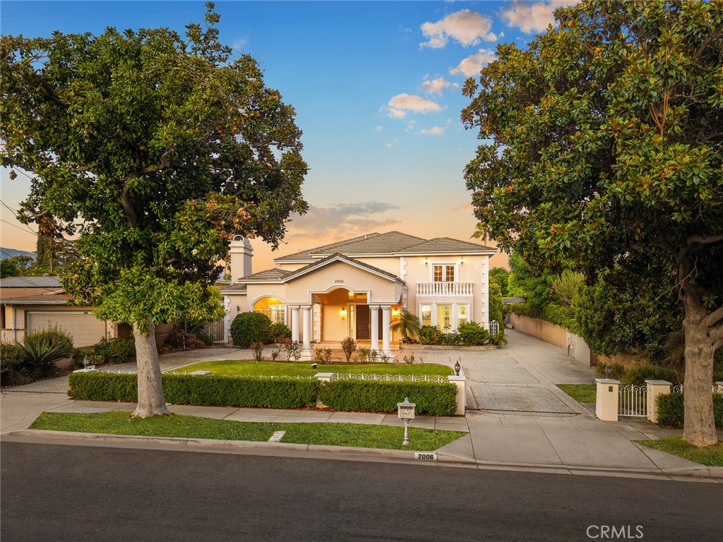 Elegant Traditional Estate in Prime Arcadia Location! Welcome to 2006 S 6th Avenue, a beautifully designed and meticulously maintained two-story estate nestled in the heart of Arcadia. Boasting 5 bedrooms and 5.5 bathrooms, this stately home offers a generous 5,568 square feet of living space on a sprawling 15,246 square foot lot. From the moment you arrive, you’ll be captivated by the striking curb appeal, featuring manicured hedges, a charming wrought-iron fence, and a grand circular driveway framed by elegant columns and arched windows. The formal double-door entry opens to a bright and expansive interior, with soaring ceilings, custom crown molding, and abundant natural light throughout.The home is thoughtfully laid out for both everyday living and stylish entertaining, with oversized formal living and dining rooms, a spacious family room, and a well-appointed chef’s kitchen that seamlessly connects to the main living areas. Each of the five bedrooms offers comfort and privacy, including a luxurious primary suite.
Outside, the long gated driveway offers ample parking and leads to a private backyard oasis with lush landscaping—perfect for hosting gatherings or simply relaxing in peace. Located in a tranquil neighborhood with convenient access to parks, shopping, dining, and the prestigious Arcadia Unified School District, this exceptional residence presents an unparalleled opportunity for refined living.