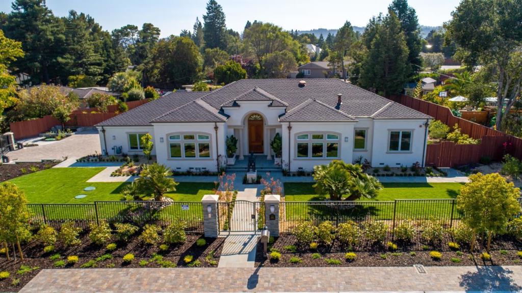 Modern with traditional French influences best describes this extraordinary, gated, and recently built home with soaring ceilings throughout. This 4600 SqFt house (garage included) masterpiece boasts a grand foyer with soaring ceilings and a sleek, well-appointed one-level design, offering four en-suite bedrooms, including a romantic master suite with a gas fireplace and folding doors for effortless flow to the yard. All four bedrooms have beautiful walk-in closets with built-in cabinetry and shelving. The oversized garage with custom cabinetry works as an extension of the kitchen storage and family room. Enjoy the California indoor-outdoor lifestyle in this lovingly custom-built home set on a corner half-acre resort-like lot featuring floor-to-ceiling glass doors that effortlessly disappear for a seamless connection to the outdoors while large windows are flooding the home with natural light at every step. The living room and dining room have floor-to-ceiling doors that fold to connect the indoors to a massive pergola-covered patio and fire pit.