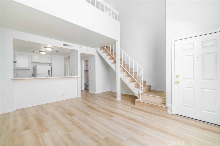Welcome to Golden Gate Square, a hidden gem near Downtown Long Beach and East Village, where modern living meets city energy and coastal light. This top-floor one-bedroom loft condo has been beautifully updated throughout. Inside, you’ll find white oak floors, new paint, new water heater, and modern vanities in both bathrooms. The open-concept floor plan features high ceilings, a skylight, and a bright loft space that’s perfect for a home office or creative retreat. Step onto your private balcony to take in panoramic views of Downtown Long Beach and the Terminal Island Bridge to San Pedro. With no neighbors above you, you’ll enjoy quiet mornings and golden-hour sunsets all your own.
Additional upgrades include a new hardware, in-unit washer and dryer, and assigned covered parking. The secure, elevator-served building offers a low HOA and well-maintained common areas, giving residents peace of mind and convenience.
Across the street, Cesar Chavez Park and the Jenny Oropeza Community Center offer green space, sports courts, and year-round activities for both kids and adults. You’re minutes from Shoreline Village, The Pike, and all the dining, coffee, and culture that make Downtown Long Beach one of Southern California’s most walkable urban neighborhoods. Whether you’re a first-time buyer or a savvy investor, this top-level loft blends comfort, character and location.