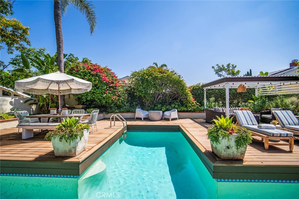 Welcome to 25135 Rivendell Dr, a stunning single-level home that has been thoughtfully remodeled to capture the essence of Southern California living. Updated with designer finishes throughout, this property offers modern elegance, seamless indoor-outdoor flow, and exceptional comfort. Step inside to discover a light-filled interior with soaring vaulted ceilings and a skylight that enhances the open-concept living space. Anchored by a gourmet kitchen with quartz countertops, dual-toned cabinetry, and a custom pass-through window that opens fully to the patio, the layout is ideal for entertaining and casual al fresco dining. The living and dining areas share the same spacious openness, creating a cohesive environment perfect for gatherings or quiet moments at home. Every room provides direct access to a private outdoor area, inviting natural light and a constant connection to the outdoors. The primary suite is a serene escape, complete with an outdoor deck, dual closets in a separate dressing area, and a stylishly renovated en-suite bathroom with dual vanities and a walk-in shower. One secondary bedroom opens to a lush garden with a bubbling fountain, while another offers views of a peaceful succulent retreat—ideal for morning coffee or quiet reflection. Outside, discover a show-stopping backyard retreat with thoughtfully designed zones for lounging, dining, and recreation. Mature landscaping frames the sparkling lap pool and cozy entertainment spaces, creating a sanctuary you can enjoy year-round, whether hosting guests or unwinding under the stars. Additional upgrades include a newer roof (2015), full home repipe (2017), fresh interior and exterior paint, and new flooring. Renovated bathrooms add a polished, designer touch. Residents enjoy exclusive access to the Lake Forest Beach & Tennis Club and walkable proximity to local schools, with easy freeway access for commuting or beach days. This rare single-story home offers more than a residence—it’s a lifestyle defined by tranquility, elegance, and quintessential California indoor-outdoor living. Schedule your private showing today and experience the charm firsthand.