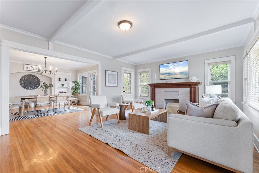 Perched above the street on one of Uptown Whittier’s desirable view-lined blocks, this 1923 Craftsman bungalow pairs historic charm with modern livability. Recognized by the Whittier Beautification Awards and showcased in city events, the home stands out immediately with its inviting front porch—an incredible spot to take in sweeping vistas stretching across Los Angeles and Orange Counties.

Inside, the home unfolds with warmth and character. Hardwood floors, preserved stained glass windows, and classic Craftsman details anchor the main living areas. The updated kitchen blends vintage style with contemporary touches, offering stainless steel appliances, a farmhouse sink, built-ins, and a cozy breakfast nook. The floor plan includes four well-appointed bedrooms and two bathrooms, with the upstairs suite enjoying abundant natural light thanks to a thoughtfully designed skylight feature.

A standout of the property is the expansive bonus room at the rear of the home. With its high ceilings and generous footprint, it has inspired countless ideas from visitors—whether as a studio, creative workspace, media room, or potential separate living area. The detached two-car garage offers similar possibilities, especially with its refreshed roof and clean structure, making it an appealing candidate for a future workshop or conversion project.

The home has also benefited from a series of meaningful upgrades completed in 2024 and 2025. Recent improvements include newly installed drainage and sewer lines, updated AC ducting, comprehensive pest management, a replaced garage roof, and a serviced above-ground spa fitted with a brand new custom cover. These updates bring confidence and comfort to the home’s next chapter.

Surrounded by mature landscaping and located just moments from Uptown’s restaurants, shops, and the Whittier Greenway Trail, this home offers a rare blend of history, character, views, and potential—all in one of Whittier’s most vibrant neighborhoods.