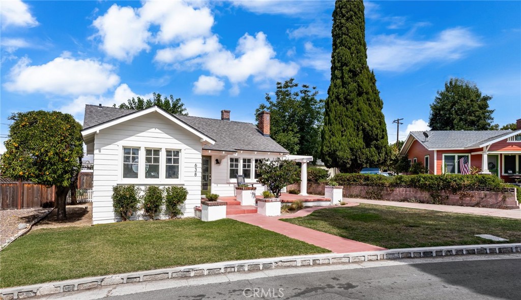 Classic South Redlands craftsman bungalow style home with a detached two car garage and a private yard on Cypress Circle! Built in 1926, this absolute charmer features a comfortable layout, tremendous character, and a killer location. You're greeted by a front lawn and sizable front porch. Enter into the living room with a brick fireplace, built in book shelves, and real hardwood floors - all flooded with natural light! Dining is adjacent, and features windows that lead out to the private backyard. The vintage kitchen is winged by indoor laundry with an adjacent storage closet. The bedrooms are on the opposite side of the house, and separated by a hallway and a full bathroom. There is new interior and exterior paint and brand new carpets. Heading out back, you'll find a sizable private yard and an oversized, detached two car garage. Cypress Circle is a very unique street. It features sidewalks in the center of the roadway, and is lined with Italian Cypress trees. It's very private, but still in very close proximity to Albertsons, Starbucks, and downtown. Excellent Redlands schools.
