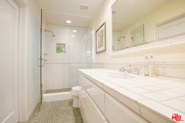 This impeccably maintained home on a double lot is situated on a private gated lane across from a beautiful sandy beach. With over 5,000 sq ft, the home is large and comfortable - perfect for full time or part time residency. Avoid the endless maintenance of living on the sand by living across from it! No home exists across the street (the lot is for deeded use) - allowing for open ocean and whitewater views from most rooms. Consisting of four levels, the master occupies the top floor and steps out to the side yard/ garden with artwork, outdoor cooking area - complete with bbq, sink and fridge - and waterfall spa. The next level down features a great room with large balcony and open kitchen - also leading outside. The floor below that has three ample sized bedrooms. Run home from the beach, rinse off the sand and step into the lower level with a large open area, laundry room, storage and wine cellar with storage for approximately 5,000 bottles.