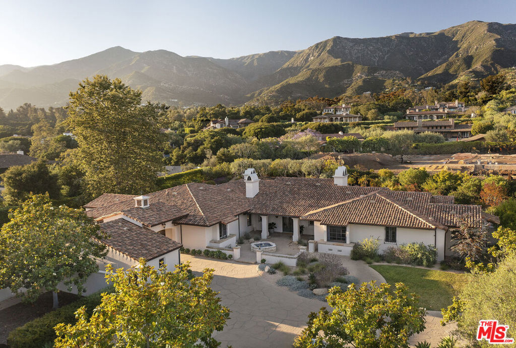 Set behind gates in Montecito's coveted Ennisbrook community, 311 Meadowbrook Drive blends timeless design with effortless California living. With soaring mountain views, vibrant gardens, and a graceful Spanish-style residence, the 1.27-acre property offers space, serenity, and style in spades. Inside, the single-level home features a light-filled mountain view living room, a formal dining area, a spacious kitchen with a breakfast area, a family room, four bedroom suites, and a home office. A 4-car garage, dog run, fruit trees, and raised garden beds complete the offering. A dedicated view easement ensures the mountain views will always be on display! Enjoy access to Ennisbrook's exclusive clubhouse, pool, tennis, pickleball, and more.
