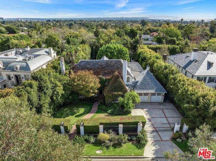 An incredible opportunity in the highly desirable Palisades Riviera. Situated on an expansive 17,456 sq ft flat lot, this private and gated residence exudes the charm and character of a classic Riviera home. The current home, hedged from the street and surrounded by lush landscaping, boasts 4 bedrooms, 3.5 baths, and 4,562 sq ft. Retaining many of its distinctive original features, 1300 Pavia offers impressive scale, gorgeous light, hardwood floors, multiple fireplaces, indoor/outdoor flow, and more!  An awe-inspiring eat-in kitchen with vaulted ceilings, redone by renowned architect and designer Steve Gianetti, opens up to a patio and large estate-like yard with a pool and mature greenery. Designer-done touches continue throughout the home. The warm and inviting living and family rooms, as well the spacious suites, serve as great canvases for the next owner. A perfect entry point into the Riv, with an opportunity to elevate, add on, or develop a world class estate. The .4 acre lot offers unbelievable potential in an unbeatable location.