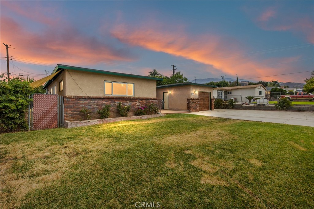 Welcome to this charming Upper Yucaipa home! Nestled in a highly sought-after neighborhood with scenic mountain views. This 4-bedroom, 2-bathroom property has a spacious layout and built-in cabinetry in the family room for stylish storage and organization. The kitchen is remodeled and includes granite countertops, updated cabinets and hardware, subway tile backsplash, large sink with pot-fill faucet, stainless steel appliances, built-in trash/recycling and a view with access to the backyard. Additional highlights include an alarm system, an attached garage with workbench and cabinets, RV parking, and storage shed. A new HVAC unit, whole house fan, dual pane windows, electrical panel and modern insulation provides for year-round comfort and energy efficiency. This home boasts attractive wood-look tile flooring in the common areas and newer carpet in bedrooms. Outdoor amenities include lemon, orange, and fig trees along with berry vines and a large flat backyard perfect for gatherings. Custom blinds and ceiling fans throughout the home enhance comfort and style. A cozy fireplace anchors the family room which connects to a bonus room for extra space - ideal for a home office, playroom, or studio. This home is move-in ready complete with TVs and all appliances - including refrigerator, washer and dryer! This home is just minutes to Yucaipa Regional Park, nearby festivals, market nights, and the world-famous Oak Glen apple orchards. Don’t miss the opportunity to own this updated home with room to grow in an established Yucaipa neighborhood!
