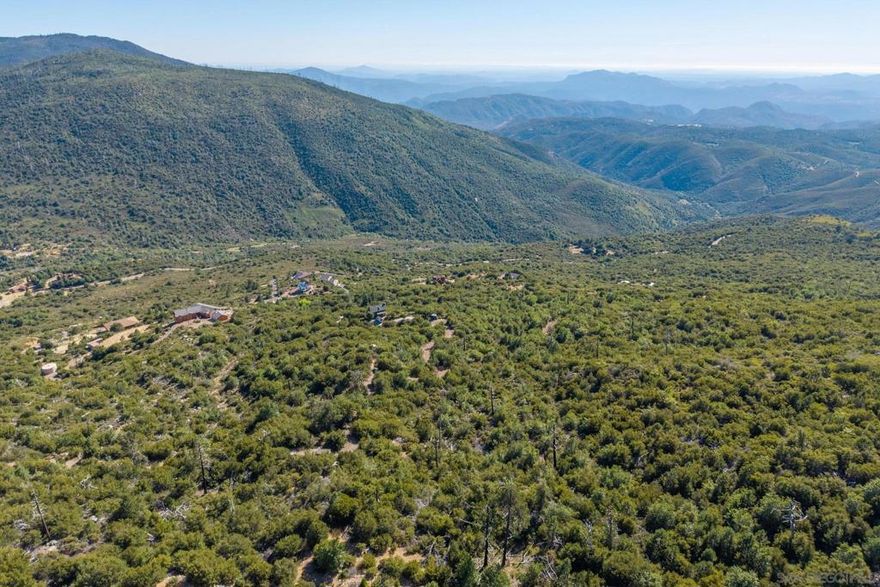 Building on this 12.06-acre parcel would present unparalleled, stunning views of the Pacific Coast from the North Peak of the majestic Three Peaks of Cuyamaca State Park. This property has a water meter and a septic system that was installed in 1993 with a 1,000-gallon tank, which has not been in use since 2003. The property previously housed a mobile home.