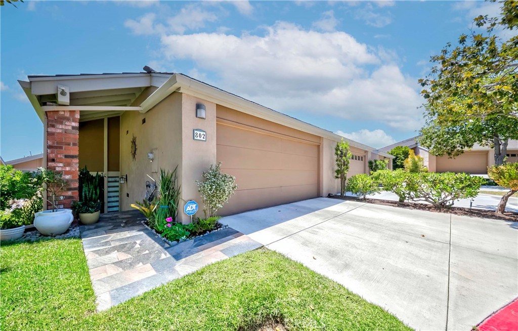 Welcome to this stylishly remodeled 3-bedroom, 2.5-bathroom end unit, ideally located on a peaceful cul-de-sac in the highly desirable Glenwood community of Fullerton. This beautifully updated home combines modern elegance with everyday comfort, offering a bright, open-concept floor plan that seamlessly connects the living, dining, and kitchen areas. The spacious living room features a cozy fireplace and sliding glass doors that lead to a private patio—perfect for indoor-outdoor living and entertaining. The renovated kitchen is equipped with quartz countertops, sleek cabinetry, a walk-in pantry, and direct access to both the dining area and patio. A separate laundry room with built-in cabinetry is conveniently located on the lower level. Upstairs, the luxurious primary suite includes a walk-in closet, greenbelt views, and an en-suite bathroom. Additional highlights include laminate flooring, ceiling fans in every room, and an attached two-car garage with direct access, plus driveway parking. Enjoy resort-style amenities including a community pool and clubhouse just steps away. Conveniently located near parks, trails, top-rated schools, shopping, dining, and major freeways. Move-in ready—this is truly a must-see home!
