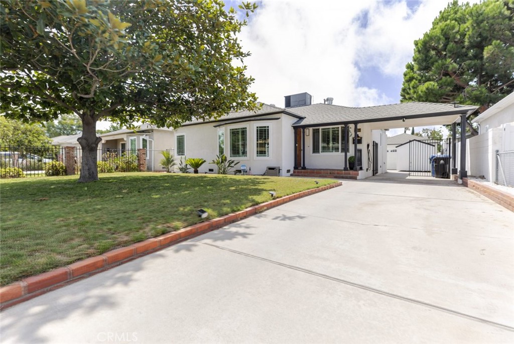 Welcome to 11484 Erwin Street, an exceptional North Hollywood residence where timeless charm meets elevated modern living. Thoughtfully renovated with strong attention to detail, this home features sleek new flooring, a custom electric fireplace, a beautifully designed guest bathroom, and a brand-new 200 amp electrical panel. The home is wired for a Level 2 EV charger under the carport as well. Other notable features include a newer roof, HVAC unit, water heater, and exterior paint. The converted garage serves as an extension of the living space, perfect for an office, creative studio, gym, or playroom. Outside, you'll find the beautifully renovated backyard offering an expansive space ideal for both intimate gatherings and grand entertaining, surrounded by beautiful trees and plants that are fully sprinklered. With ample room to build both an ADU and a Jr. ADU, the property offers versatility and tremendous potential for luxurious multi-generational living or future expansion. Blending beauty, functionality, and endless possibilities, this remarkable home is a rare offering in one of the most sought-after neighborhoods in the Valley.