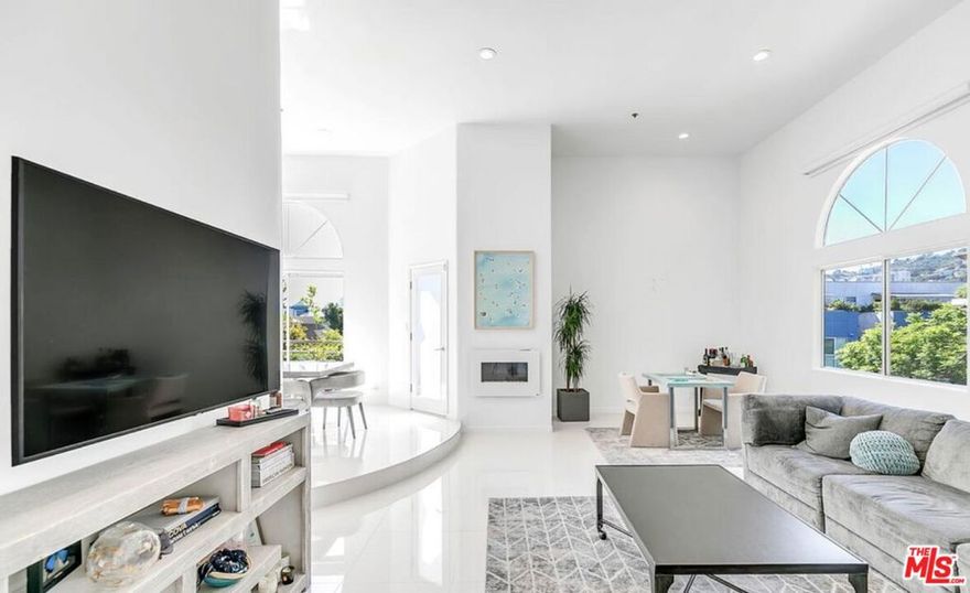 Penthouse living at its finest! Seconds away from Melrose Place, this completely renovated top-floor 2 bed/2 bath penthouse features oversized windows that let in an abundance of natural light and showcase views of all West Hollywood has to offer. At nearly 1,600 sq. ft. with extended-height ceilings, the condo feels grand in every room. Both bedrooms are spacious, with the primary featuring a spa-like ensuite and large walk-in closet. The kitchen is spotless with all stainless steel appliances and opens nicely into the living and dining areas - perfect for entertaining. This pet-friendly unit includes 2 garage parking spaces, a private balcony for soaking up the sun, an in-unit washer/dryer, and central AC/heat. If you are looking for luxury in WeHo where no car is needed, look no further.