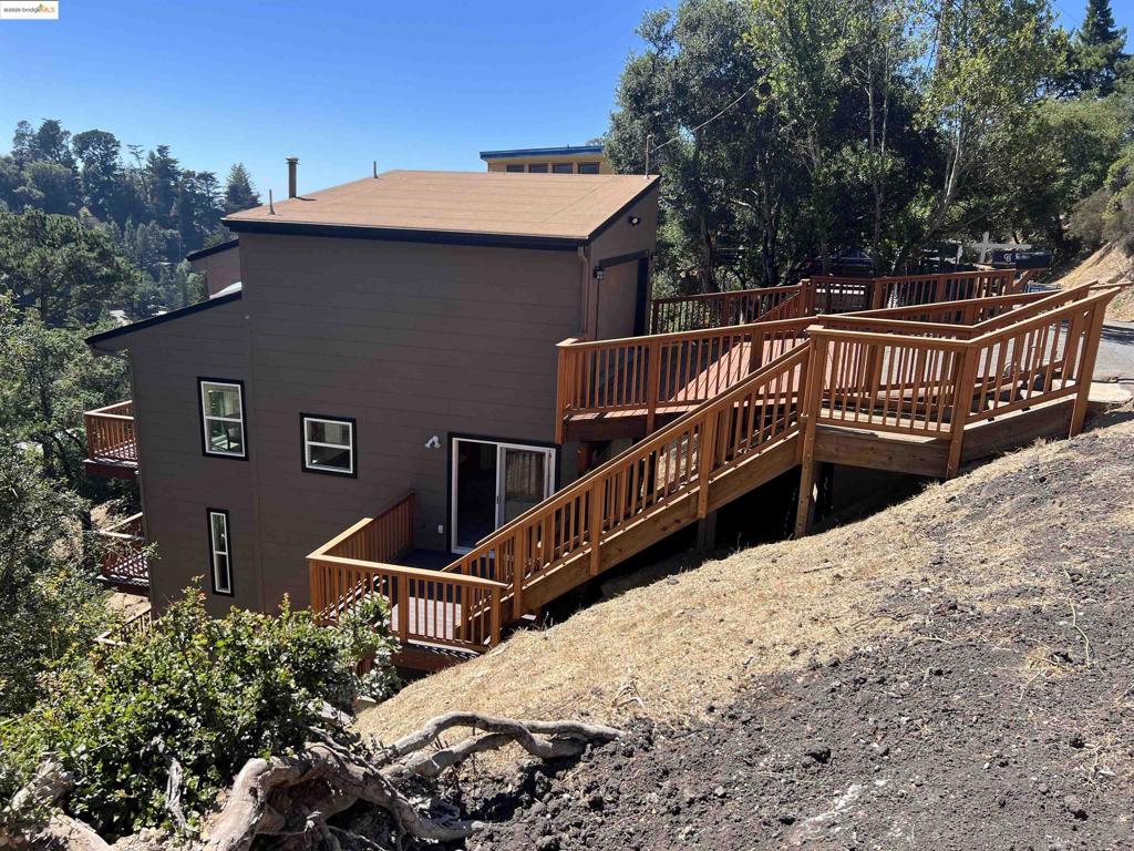 Spacious, Stylish, & Sun-Soaked—A Creekside Contemporary w/Bay Views! & the adjacent vacant lot is included in this price! 3.5 bedrooms & 2.5 baths. Discover refined comfort & elevated design with approximately 2,693 square feet of light-filled living space, this home offers a striking balance of privacy, scale, & natural beauty. Step inside to find soaring ceilings that open up the living & dining areas, creating a dramatic & airy ambiance. All-new exterior doors and windows frame glimpses of the North Bay and lush greenery, inviting nature & sunlight into every room. New carpeting throughout adds a soft, modern touch to the already warm & welcoming interior. Whether you're enjoying a peaceful moment on the deck or entertaining in the spacious great room, you'll appreciate the home's partial peek-a-boo views of the Bay, along with its sunny southwestern exposure—ideal for afternoon light and golden sunsets. Set along a seasonal creekside setting, this property delivers a rare combination: a tranquil, almost woodland vibe, yet just minutes from Montclair Village shops, cafés, & top-rated schools. Key Features: All new exterior doors and windows, New carpeting throughout, Vaulted ceilings on the main, Peek-a-boo North Bay views,Creekside setting.