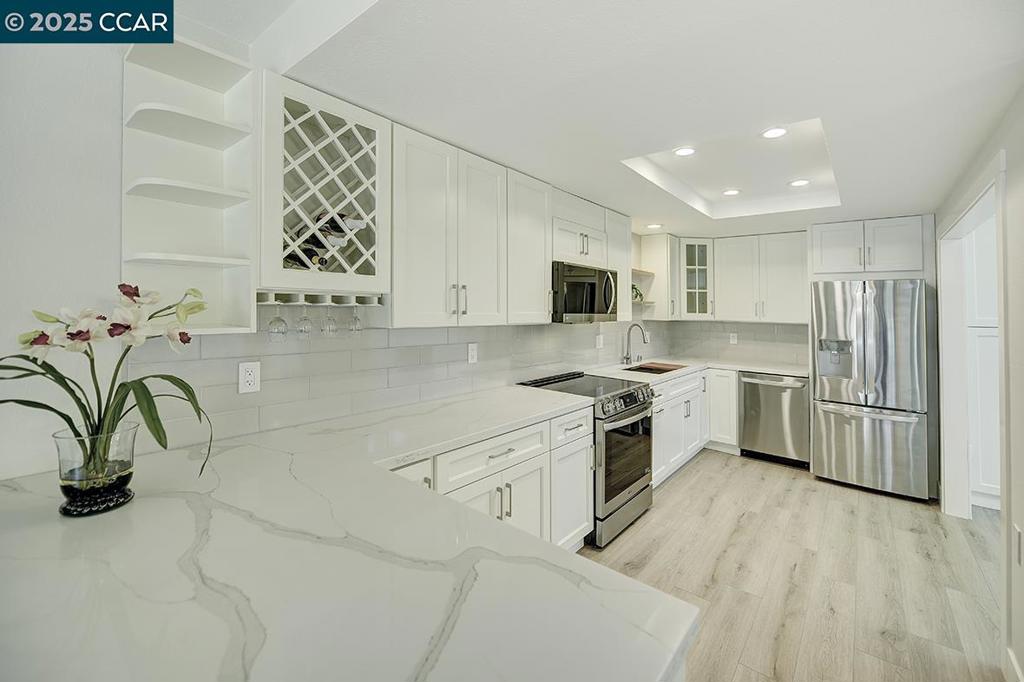Beautifully remodeled 2 bed, 1.5 bath Golden Gate model with no steps to entry that is highly valued in a 55+ community! This sought-after corner end unit features a bonus room with built-ins, soaring ceiling, clearstory windows for abundant natural light. The stunning kitchen offers quartz counters, white tile backsplash, LG SS appliances, and recessed lighting. Enjoy updated baths, new flooring, double-paned windows, and coveted in-unit laundry. Floor to ceiling closets. Includes lighted covered parking space #4 with a storage closet. Located in Rossmoor’s 55+ gated community with game/hobby rooms (woodworking, art, lapidary, ceramics, sewing) golf, pools, bocce ball, pickleball, tennis, table tennis, picnic areas, incredible fitness center, 10 miles of hiking trails, concerts, dinners, library, dances, lectures, 200+ clubs (large bridge club), hiking/walking trails, excursions, and more! Explore your talents, enjoy friends and family, and stay active! It is all about you now!