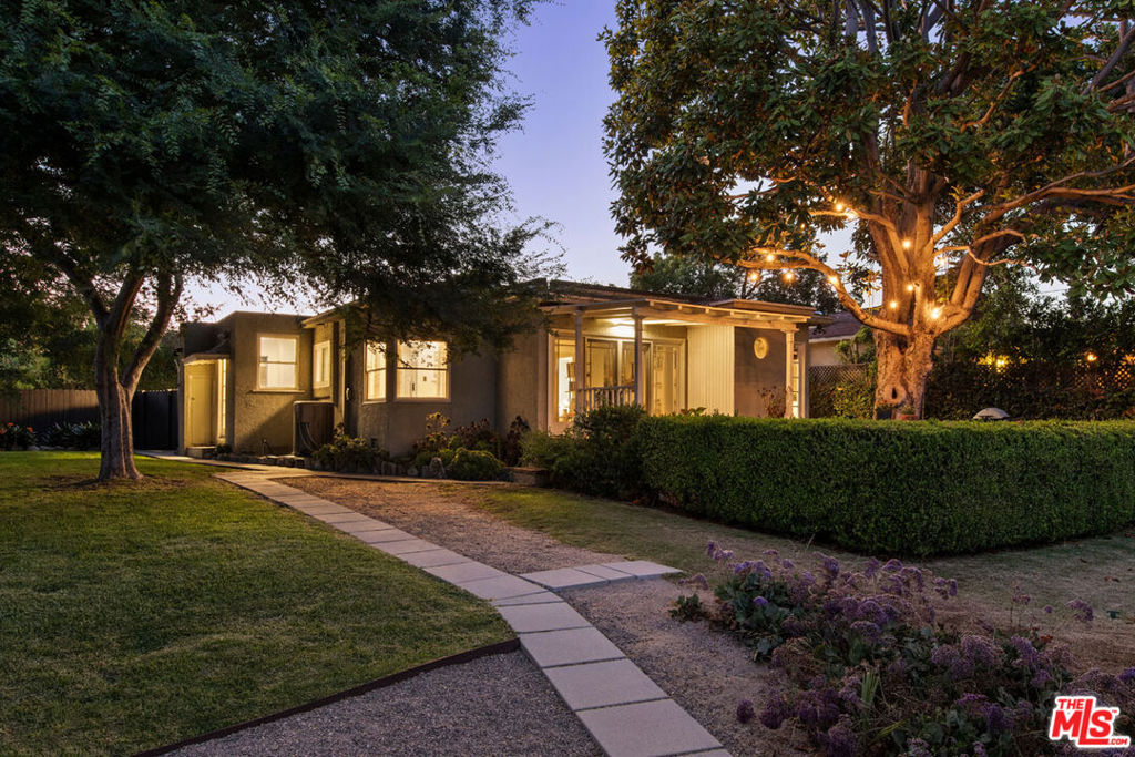 Nestled in Montecito Heights, this 1937 bungalow is your hillside hideaway with gorgeous views and an expansive yard. The spacious interior is filled with sunshine and period charm, featuring wood flooring, built-in cabinetry, and distinctive corner windows. Sliding glass doors lead to a covered patio and deck, a picturesque setting for outdoor dining and taking in the vistas. The updated galley kitchen is bright and cheerful, with ample storage and direct access to the yard. Two bedrooms include one with French doors to the patio, an easy guest room or home office. The flat backyard feels like a private retreat, with room to relax, gather, and enjoy the stunning scenery. Amenities include central air, laundry, and two-car garage. The serene location is close to Debs Park and local favorites Highly Likely, Villa's Tacos, Fresco Market, and more.